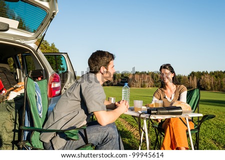 Camping car happy young couple enjoy picnic sunny countryside