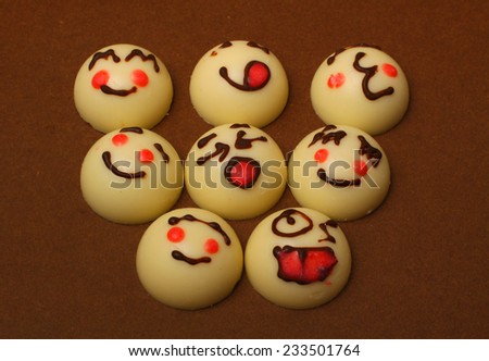 Smile face made of chocolate   is isolated on a brown background