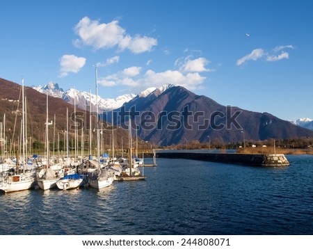 Lake of Como, Italy. Port of Gera Lario with moored boats and mountains. Boats moored in the harbor