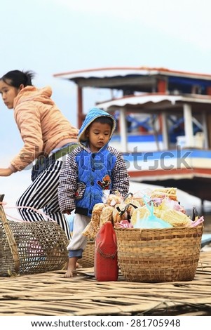 LUANG PRABANG, LAOS - FEBRUARY 11: People waiting for the ferryboat to cross the river to be back to their village after their daily shopping, Luang Prabang, Laos on the 11th February, 2015.