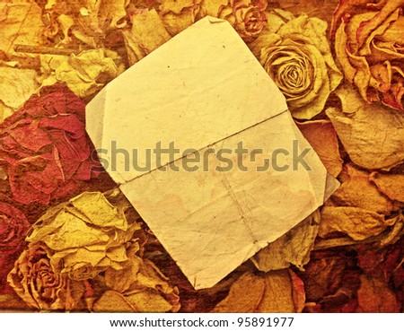 scrap of paper on dryed roses - picture in artistic retro style