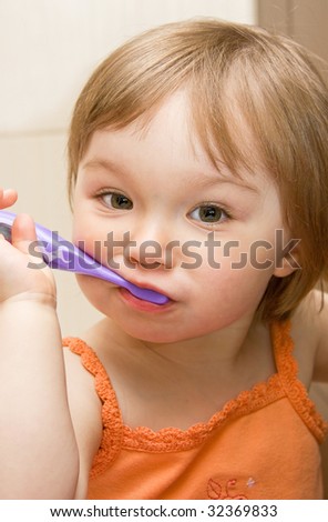 sweet toddler baby girl cleaning teeth