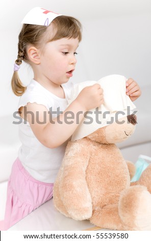 little girl doctor with teddy bear