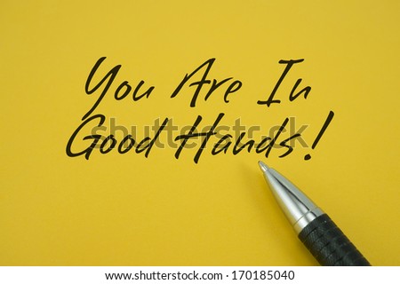 You Are In Good Hands note with pen on yellow background