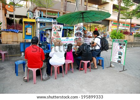 KRABI - THAILAND - JULY 9: Mobile vendor sell fast food on a street on July 9, 2011 in Krabi, Thailand. Street food is popular snack type in Asia.