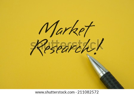 Market Research! note with pen on yellow background