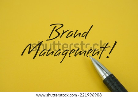 Brand Management! note with pen on yellow background