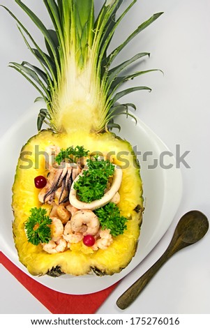 Shrimp salad served in pineapple on white background.Seafood.