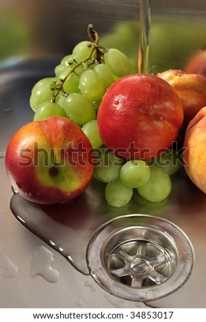 Washing fruits in stainless steel sink