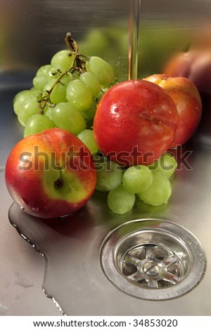 Washing fruits in stainless steel sink