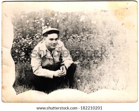 USSR  - CIRCA 1965s: An antique photo shows Man sitting in a field