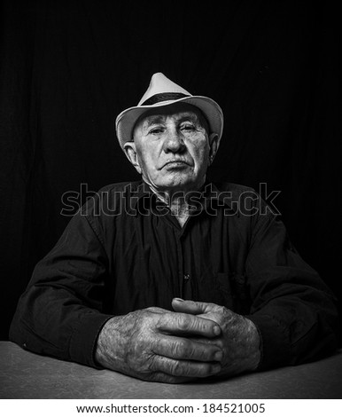 Artistic portrait of an old man in a hat