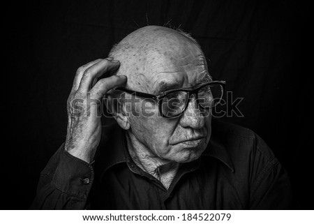 Artistic portrait of an old man with glasses