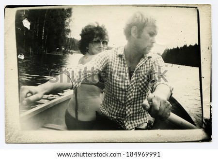 USSR - CIRCA 1970s : An antique photo shows  man and woman traveling by boat