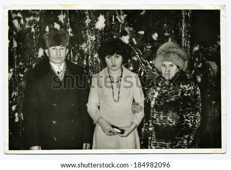USSR - CIRCA 1960s: Christmas family portrait on the background of trees