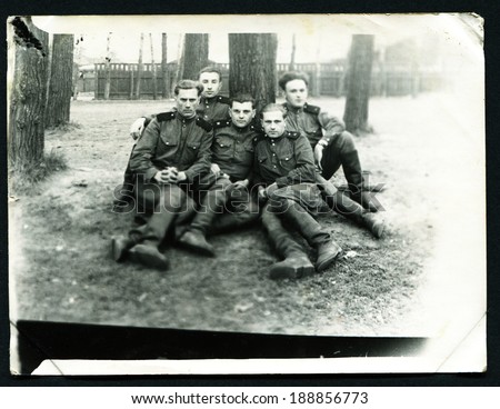 USSR - CIRCA 1953: Postcard shows five soldiers sitting under a tree, of the USSR, 1953