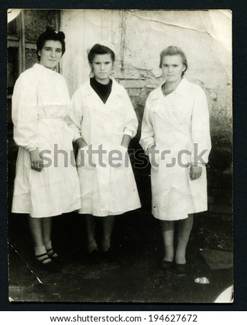 USSR - CIRCA 1950s: An antique photo shows three women in white coats, USSR, circa 1950s