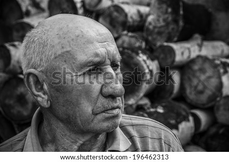 portrait of a sad old man on a background of chocks