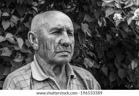 portrait of a sad old man on a lilac background