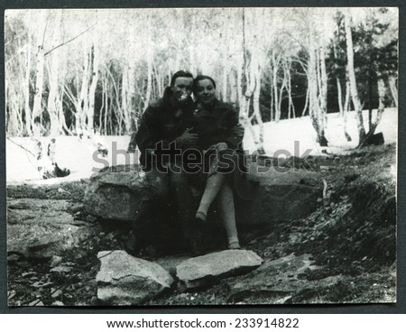 USSR - CIRCA 1970s: An antique photo shows Man and woman sitting on a rock in the forest