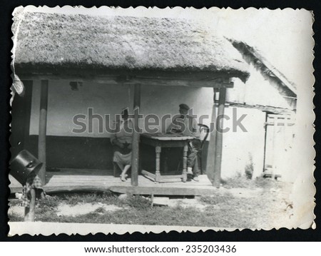 USSR: Ukraine - CIRCA 1930s: An antique photo show old man and woman sitting on the porch