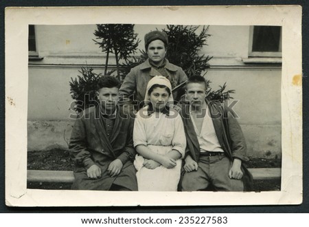 USSR - CIRCA 1940s: An antique photo show Three soldiers and a nurse, period of WWII