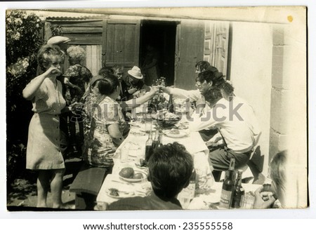 Ussr - CIRCA 1980s: An antique Black & White photo show feast outdoors