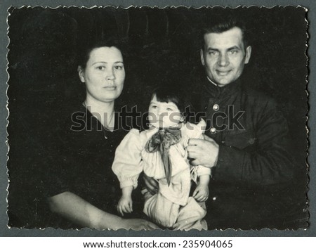 Ussr - CIRCA 1970s: An antique Black & White photo show parents with daughter
