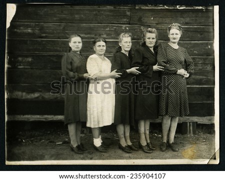 Ussr - CIRCA 1970s: An antique Black & White photo show five women on the background of wooden wall