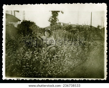 Ussr - CIRCA 1970s: An antique Black & White photo show woman and wild flowers