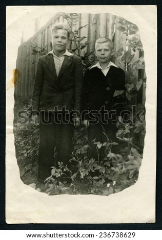 Ussr - CIRCA 1970s: An antique Black & White photo show two brothers in the garden