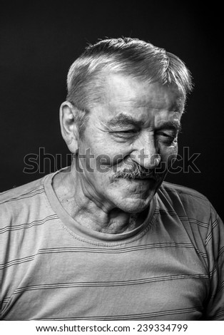 Laughing old man on a black background