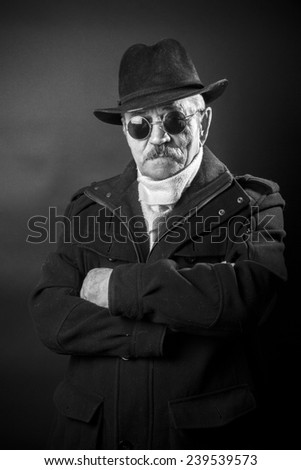 portrait of an old man in black glasses