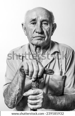 old man sitting in the armchair with his walking stick