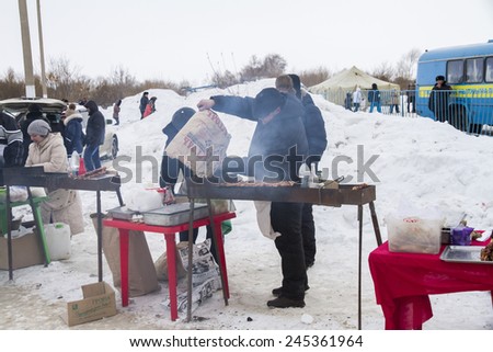PETROPAVLOVSK, KAZAKHSTAN- JANUARY 19, 2015: man cooks barbecue. Orthodox church Holy Epiphany Day