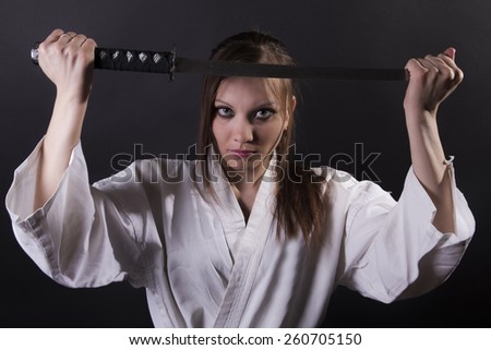 karate girl on black background studio shot