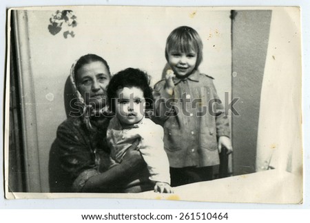Ussr - CIRCA 1970s: An antique Black & White photo show grandmother with two grandchildren