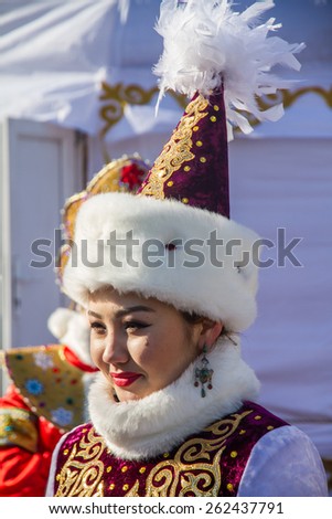 PETROPAVLOVSK, KAZAKHSTAN - MARCH 21, 2015: celebration of the new year on the solar calendar astronomical in Iranian and Turkic peoples. Beautiful girl in national headdress