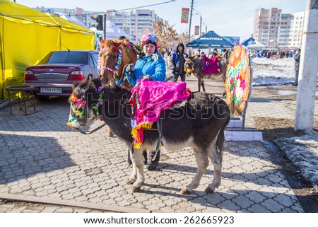 PETROPAVLOVSK, KAZAKHSTAN - MARCH 21, 2015: celebration of the new year on the solar calendar astronomical in Iranian and Turkic peoples. Girl with pony