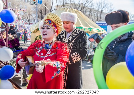 PETROPAVLOVSK, KAZAKHSTAN - MARCH 21, 2015: celebration of the new year on the solar calendar astronomical in Iranian and Turkic peoples. Girl playing the lute and sings
