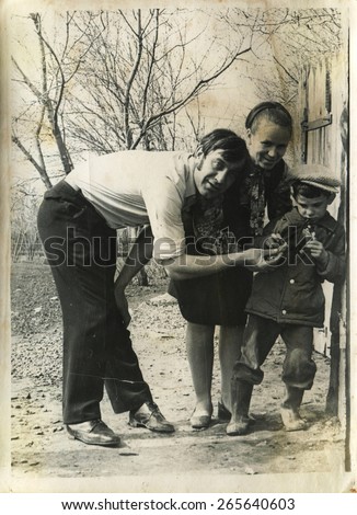 Ussr - CIRCA 1970s: An antique Black & White photo show parents with son