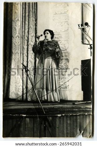 USSR - CIRCA 1980s: An antique photo show The woman singing on stage