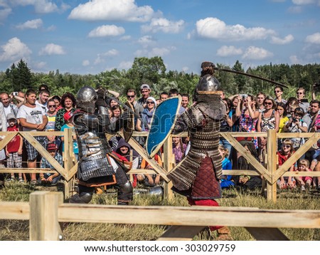 OMSK, RUSSIA - AUGUST 1, 2015: Unidentified participants in medieval fight at a historical reenactment festival \