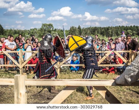 OMSK, RUSSIA - AUGUST 1, 2015: Unidentified participants in medieval fight at a historical reenactment festival 