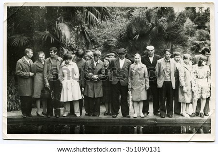 Ussr - CIRCA 1950: An antique Black & White photo show a group of tourists at a resort in the background of palm trees