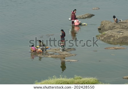 Maharashtra India, November 6th 2006:Women washing clothes in water of a river in Maharashtra India.