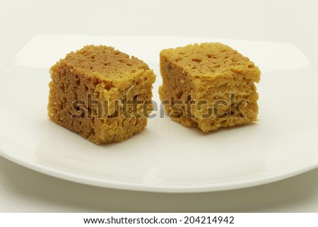Indian sweet: Mysore pak - Sweet Dish Made From Lentil Flour. in white dish on white background.