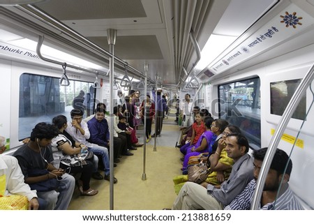 MUMBAI, INDIA - August 29th 2014:Latest Mumbai Metro train running and commuters sitting & standing in the metro. Comfortable, modern , fast, new & air conditioned way of transport in Mumbai India.
