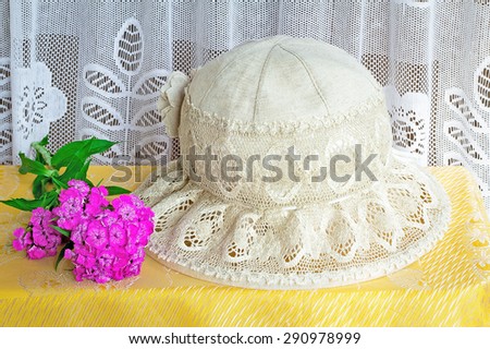 Female hat from linen fabric and lacy fabric for protection against the sun. It is a subject for summer holiday.