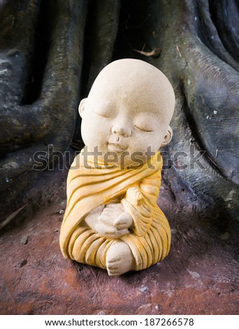 A child monk sculpture on meditation at a temple in Thailand